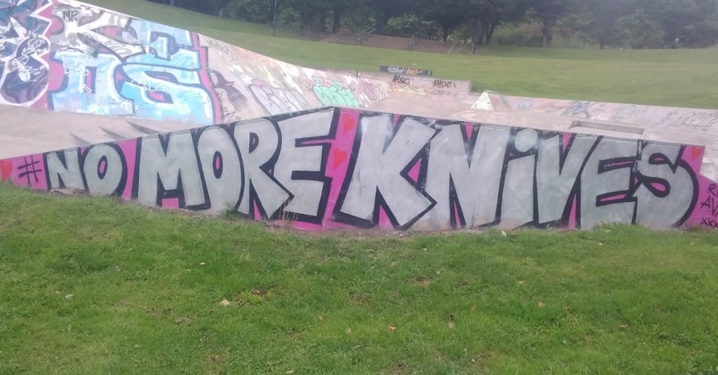 Colourful graffiti on wall of skate park declaring 'No more knives' in response to the killing of Ava White.