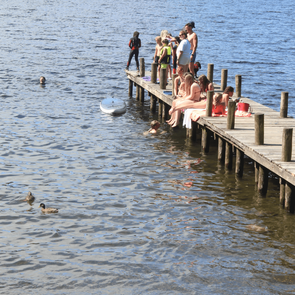 Tourists crammed onto a jetty for water sports activities.