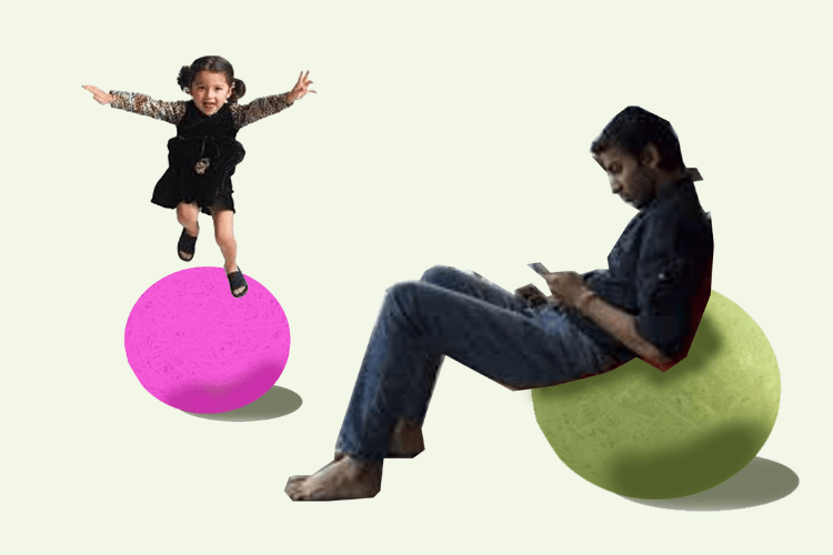 Image of young girl jumping on ball structure and male adult sitting on structure while browsing on a mobile device.