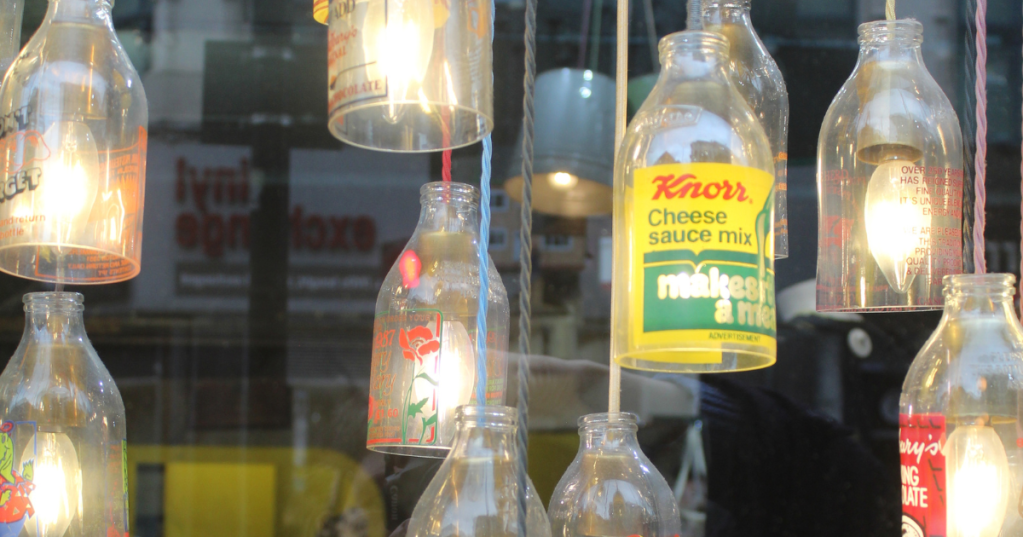 Close up of re-claimed glass bottles as lights in a shop Manchester Northern Quarter.