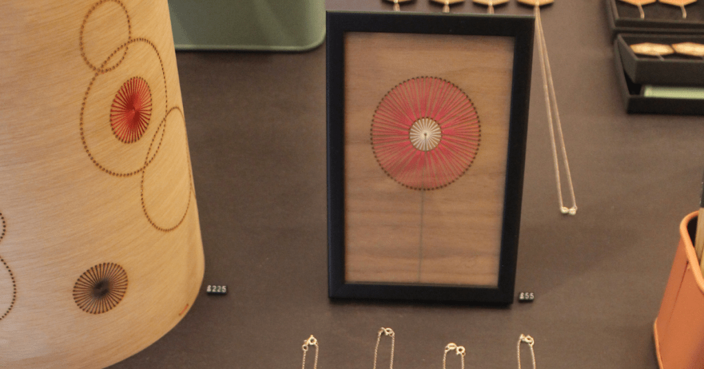 Close up of framed work and lamp created by Jane Blease.