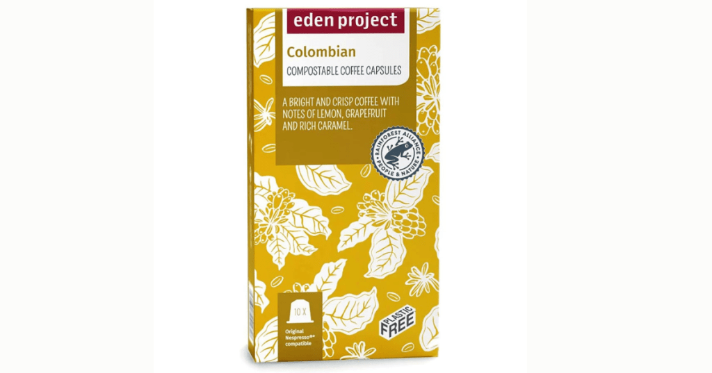 A yellow box of Eden Project compostable coffee capsules, Colombian variety, featuring white illustrations of coffee plants and flowers. The front of the package includes the Eden Project logo, a "Rainforest Alliance Certified" seal, and a "Plastic Free" label. Text describes the coffee as "A bright and crisp coffee with notes of lemon, grapefruit and rich caramel." The bottom of the box states it contains "10 x Original compostable capsules." The design emphasises sustainability and ethical sourcing.