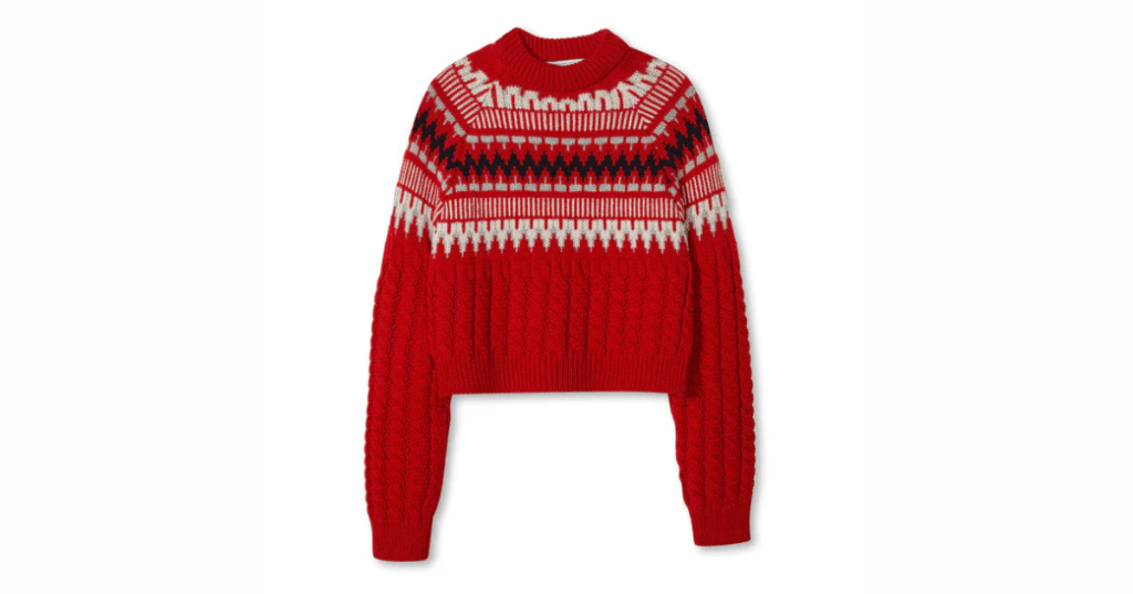 A cosy jumper featuring a bold red and white geometric pattern.