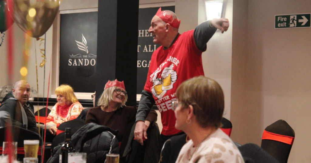 Lena Sena and Billy Marrat, Anfield Labour Councillors, find time to connect during this festive celebration.