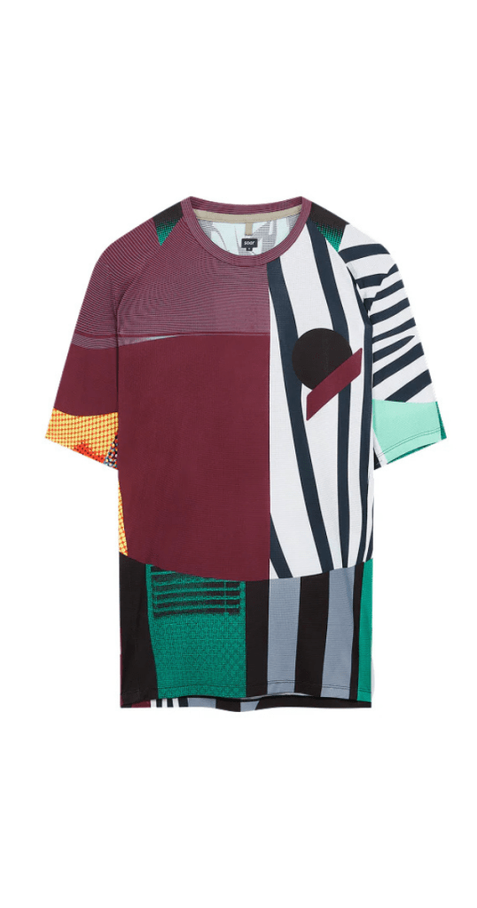 Men's short-sleeved running t-shirt with bold geometric patchwork design in maroon, teal, black, white, yellow, and green. Features asymmetrical stripes, pixel textures, and circular accents. Round neckline —modern, artistic, and statement-making.