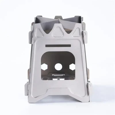 Compact & Durable Camp Stove For Hiking shown folded and ready for outdoor use, featuring a metal body with ventilation holes and a cross‑shaped pot support for efficient cooking on the trail.