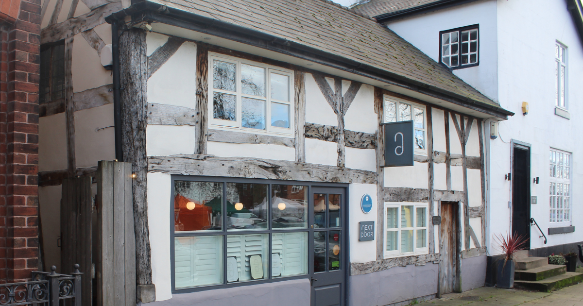 Timber‑framed shopfront on Main St, Frodsham, featuring exposed beams, white plaster walls, and modern signage for a cosy independent business with warm lighting visible through the window.