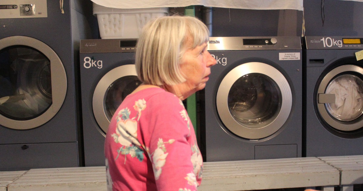 Ruth Knox in front of washing machines inside Kitty’s Launderette during a campaign meeting to reinstate a library for Anfield and Everton.